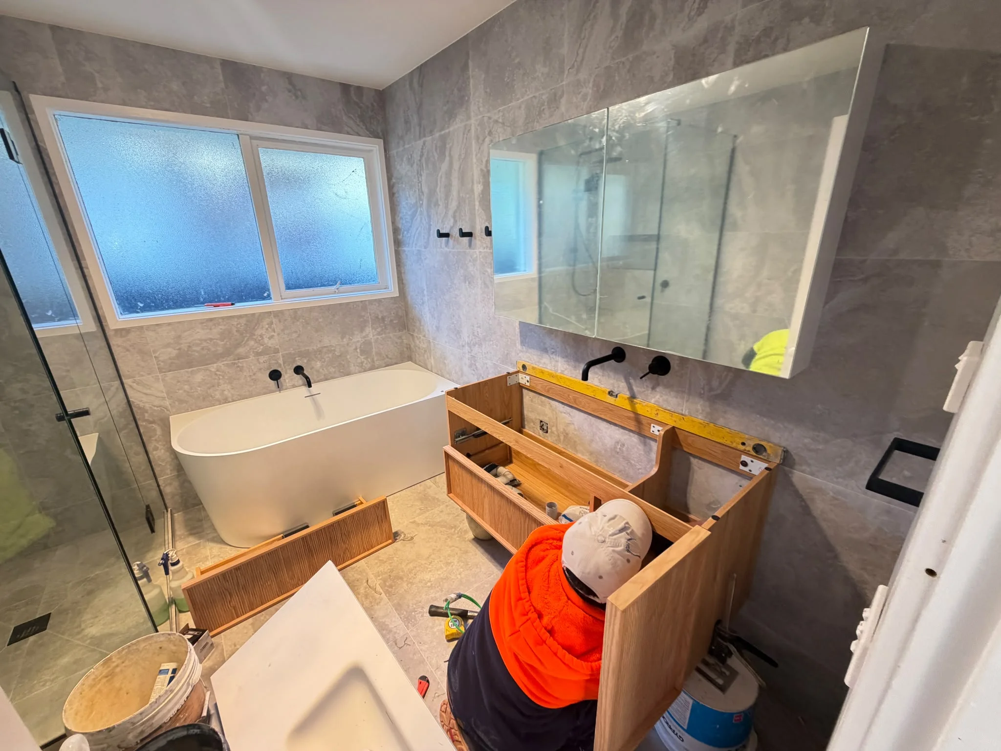 Team member fitting a vanity during a bathroom renovation